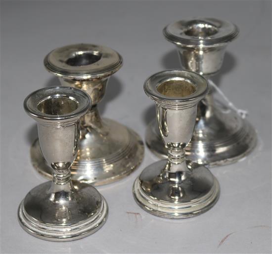 A pair of silver dwarf candlesticks and a plated pair
